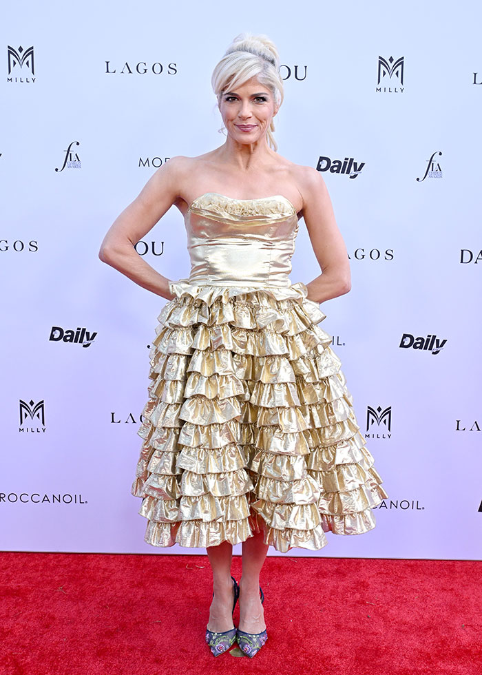 Selma Blair mostrando una personalidad increíble con vestido de oro con volantes en la alfombra roja.