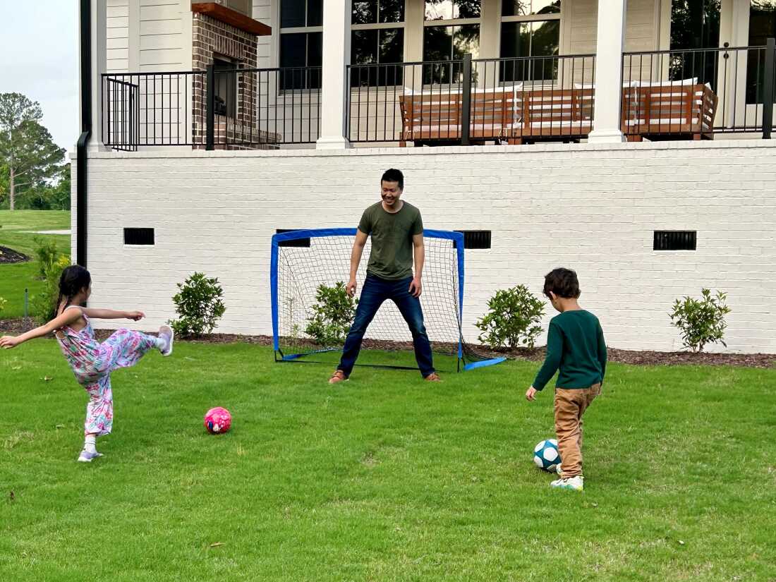 Jim Xiao le pagó a un agente una tarifa fija de $ 10,000 para ayudarlo a comprar una casa en Evans, Georgia, el año pasado. Aquí, Xiao y sus hijos juegan fútbol en su nuevo hogar.