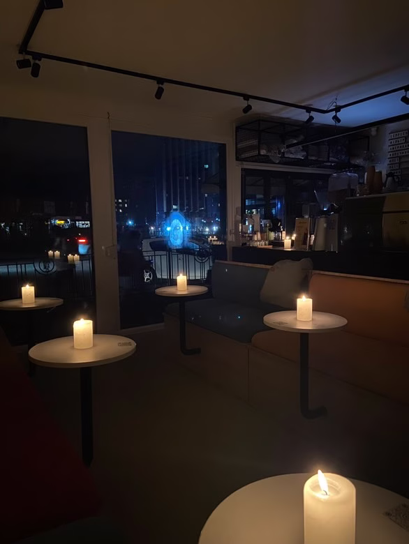 Un café en Kyiv, Ucrania, se muestra iluminado por velas durante un apagón.