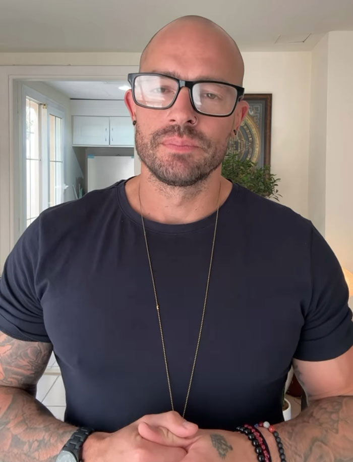 Hombre con gafas y tatuajes en el interior, el ex bailarín de pole se volvió monje que provocó reacciones mixtas con su historia