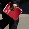 Una persona tiene una carpeta de Harvard College durante una gira en la Universidad de Harvard el 17 de abril en Cambridge, Mass.