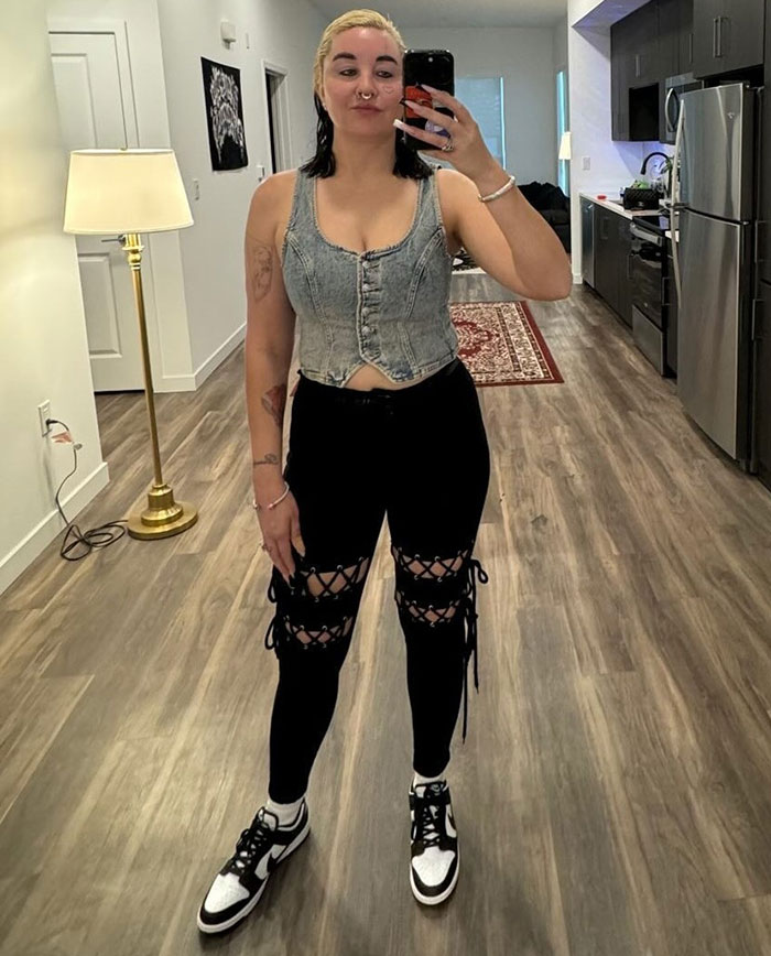 Amanda Bynes tomando una selfie en interiores con una tapa de mezclilla y pantalones negros, después de revelar que está usando Ozempic.