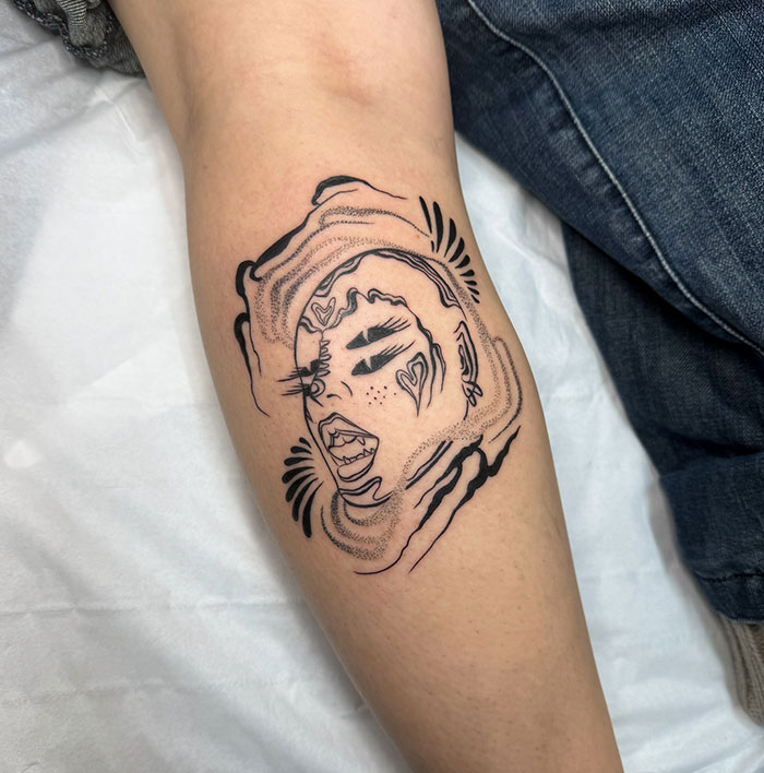 Encubrimiento de tatuaje de tinta negra abstracta en el antebrazo, mostrando la habilidad de un artista de tatuajes en los encubrimientos de tatuajes creativos.
