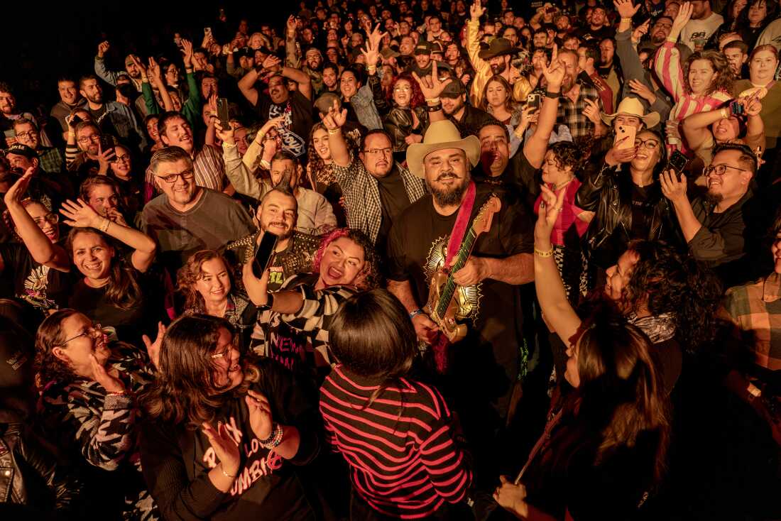 UNITED STATES, LA - Pedro Zapata, known as Pedro Pistolas, guitar player and vocalist in Spaghetti Cumbia, plays his guitar surrounded by the crowd at a show El Rey Theater in Los Angeles on December 29, 2024. The band Spaghetti Cumbia created their own sub-genre by combining cumbia with western styles and rock ’n roll. They grew up on the east side of Los Angeles when gang violence plagued the area; the members turned to music as an alternative path. Now, they rock clubs, while keeping day jobs to support their families.