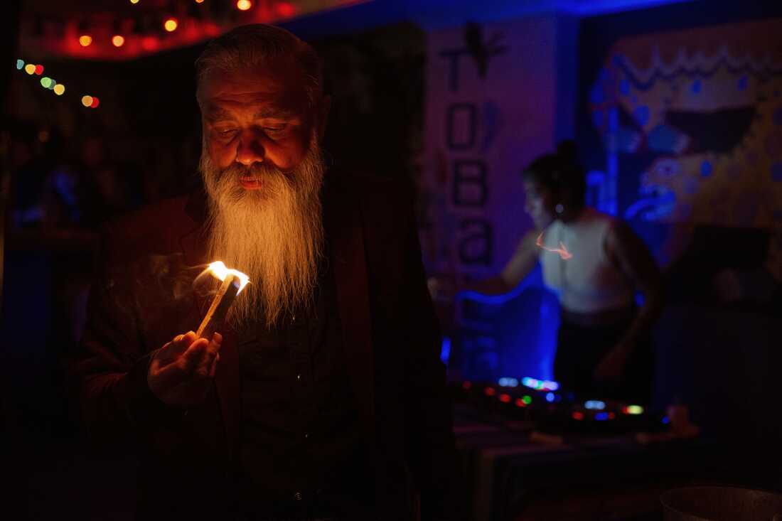 UNITED STATES, LA - Marcel Campos lights a stick of palo santo, a ritual to bring good energy to the room, before a show at Las Perlas in Los Angeles on April 28, 2022. The band Spaghetti Cumbia created their own sub-genre by combining cumbia with western styles and rock ’n roll. They grew up on the east side of Los Angeles when gang violence plagued the area; the members turned to music as an alternative path. Now, they rock clubs, while keeping day jobs to support their families.