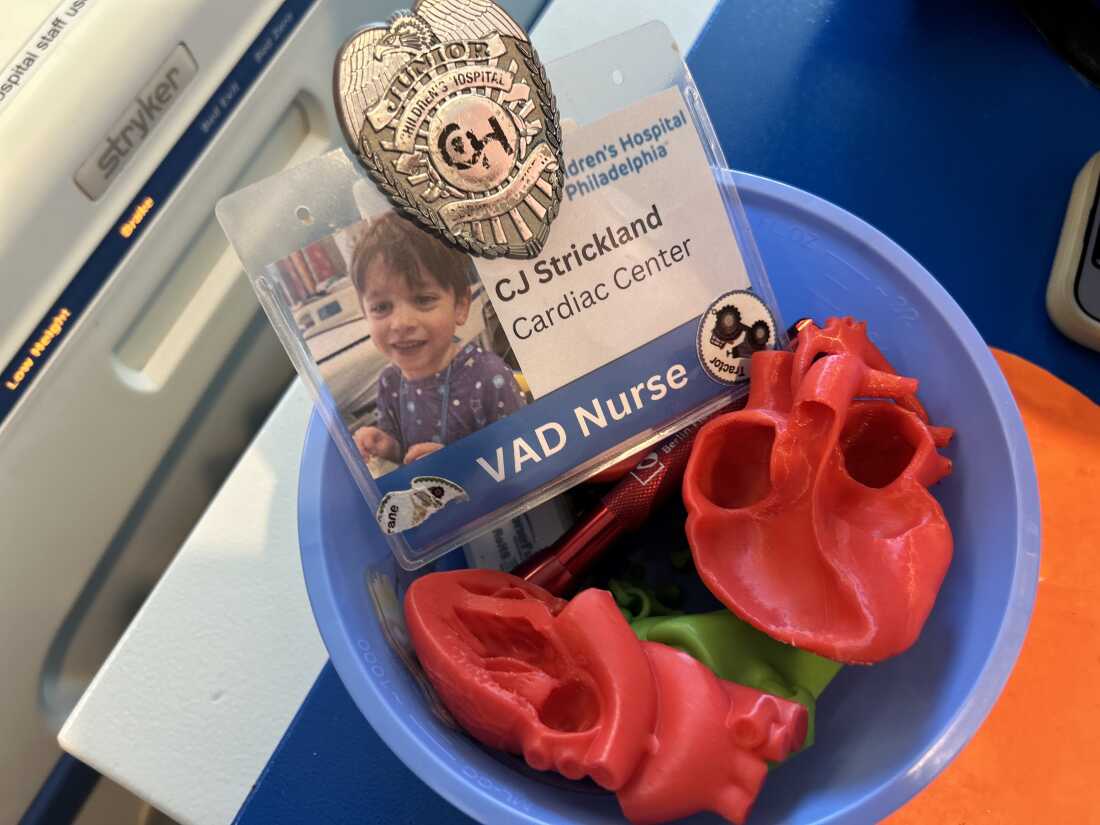 A plastic heart and a play name tag in Caleb's hospital room.