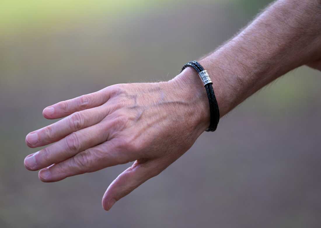 This photo shows Ned Place's hand and forearm. Around his wrist is a bracelet with the names of his three born children, including Ingrid.