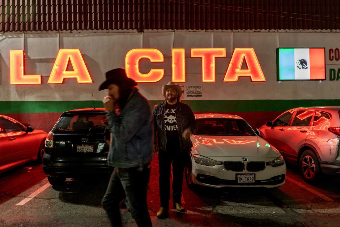 Bobby Guerrero, known as El Gallo, the guitar player, and Pedro Zapata, known as Pedro Pistolas, guitar player head to their show at La Cita, in Los Angeles on March 15, 2025.