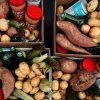 Una fotografía aérea y en primer plano de cuatro cajas de cartón, cada una llena de alimentos frescos y no perecederos, juntas formando un cuadrado. Las cajas contienen batatas, patatas blancas, tarros de mantequilla de maní, maíz fresco, latas de sopa de champiñones y botellas de vidrio verde.