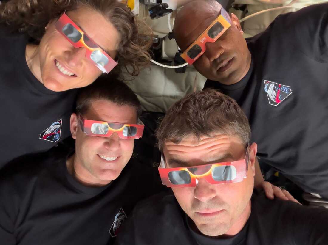 The Artemis II crew — mission specialist Christina Koch (top left), Glover (top right), Hansen (bottom left) and Wiseman — use eclipse viewers to protect their eyes at key moments during the solar eclipse they experienced during their lunar flyby. This was the first use of eclipse glasses at the moon to safely view a solar eclipse.